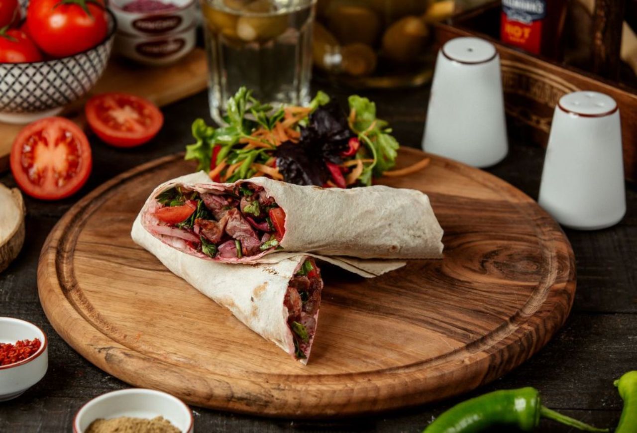 side-view-doner-kebab-wrapped-lavash-with-fresh-salad-wooden-board.jpg